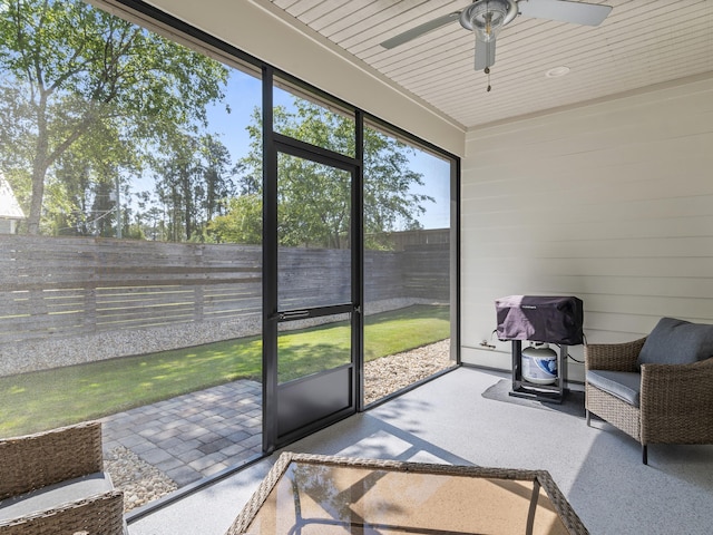 sunroom / solarium featuring ceiling fan