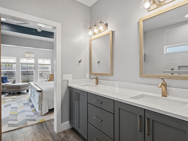 bathroom featuring wood-type flooring, a tub, and double vanity