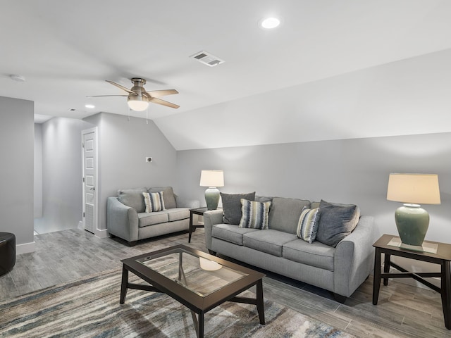 living room with wood-type flooring, ceiling fan, and vaulted ceiling