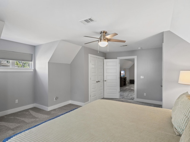 carpeted bedroom featuring a closet, ceiling fan, and lofted ceiling