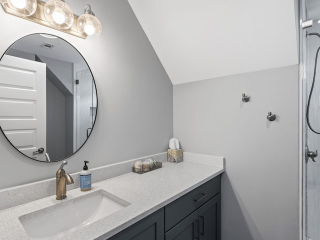 bathroom featuring vaulted ceiling and vanity