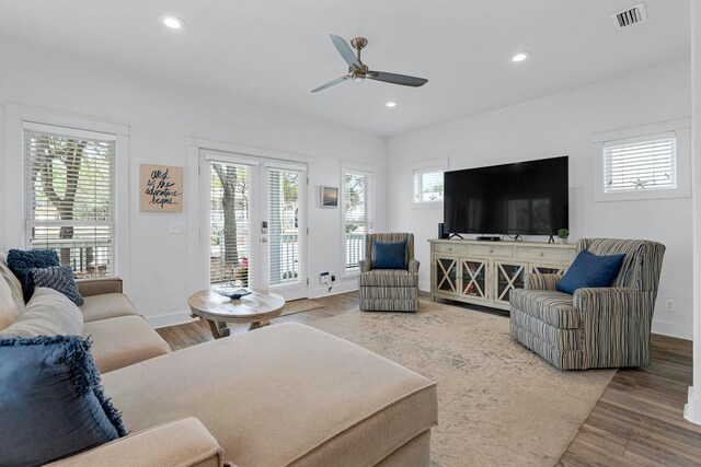 living room with hardwood / wood-style floors and ceiling fan