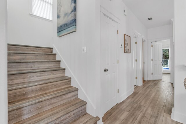 stairway with hardwood / wood-style floors