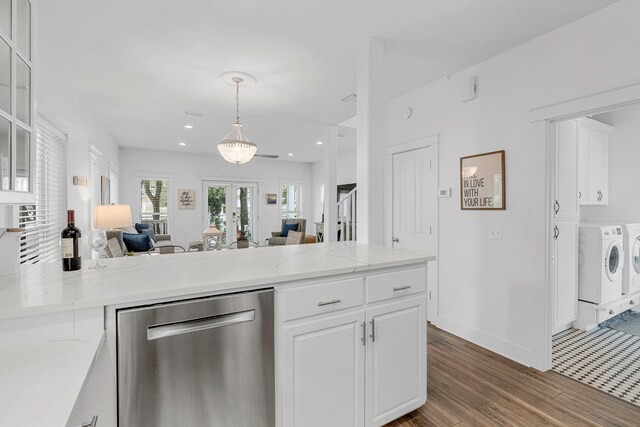 kitchen with dishwasher, washing machine and dryer, light stone countertops, decorative light fixtures, and white cabinetry