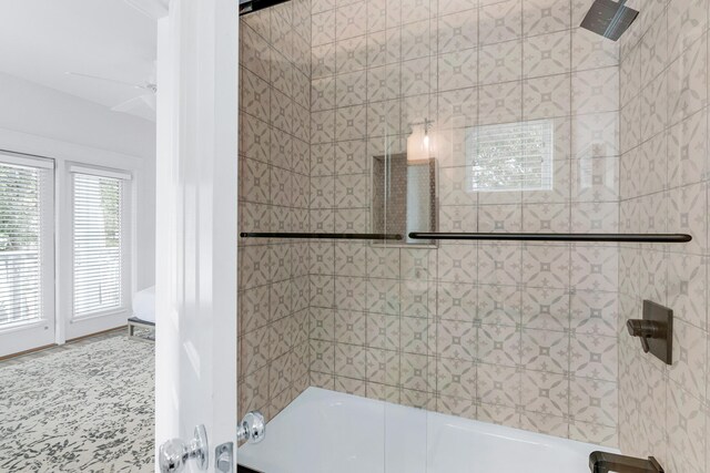 bathroom featuring combined bath / shower with glass door