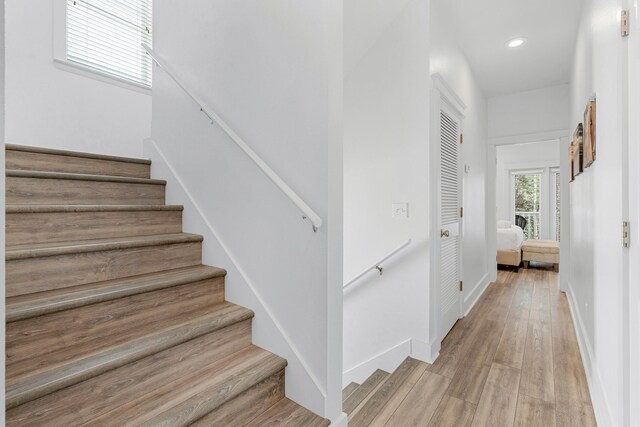 staircase with hardwood / wood-style floors