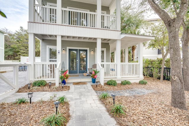 exterior space featuring a balcony and french doors