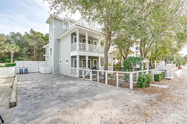 front of property with a balcony and a porch