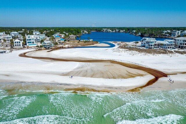 aerial view with a water view and a beach view