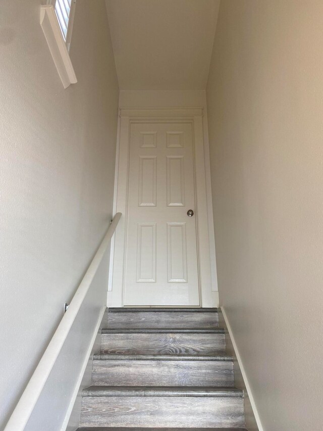 stairway with hardwood / wood-style floors