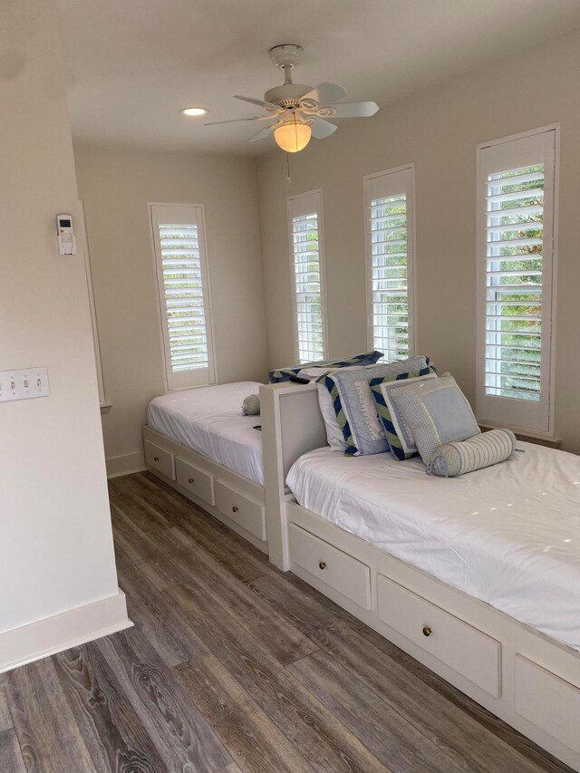 bedroom with ceiling fan and dark wood-type flooring