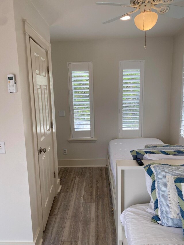 bedroom featuring ceiling fan and dark wood-type flooring