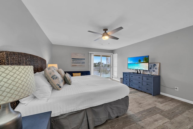 bedroom with hardwood / wood-style floors, ceiling fan, and access to outside