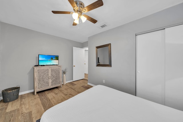 bedroom with hardwood / wood-style floors, a closet, and ceiling fan