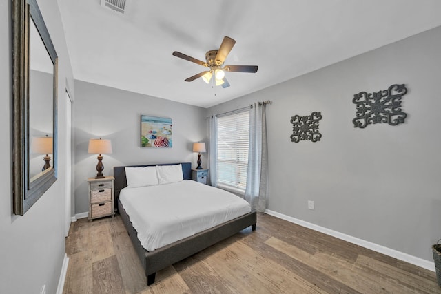 bedroom with hardwood / wood-style floors and ceiling fan