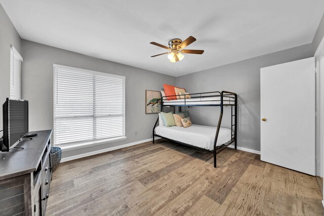 bedroom with wood-type flooring and ceiling fan