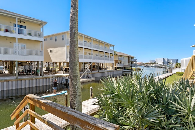 view of dock featuring a water view and a balcony