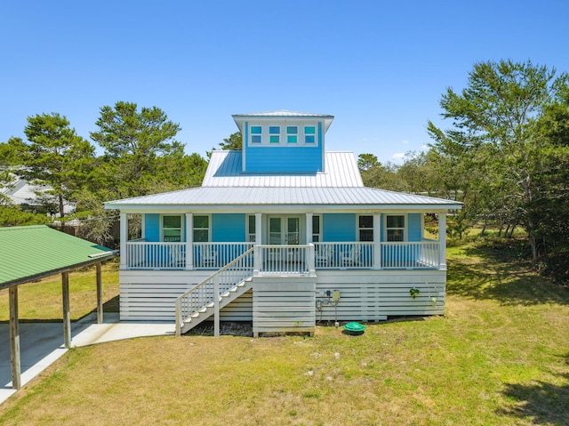 rear view of house with a porch and a lawn