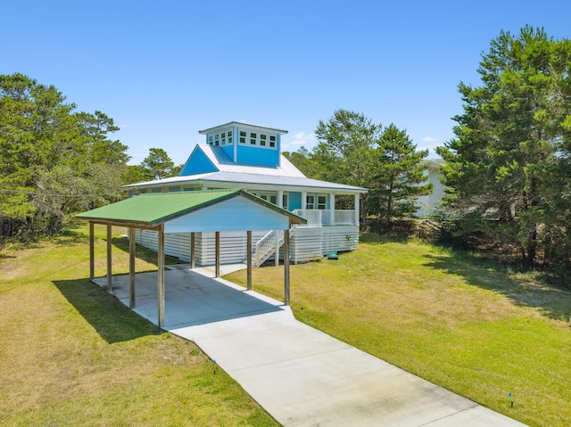 farmhouse inspired home with a carport and a front lawn