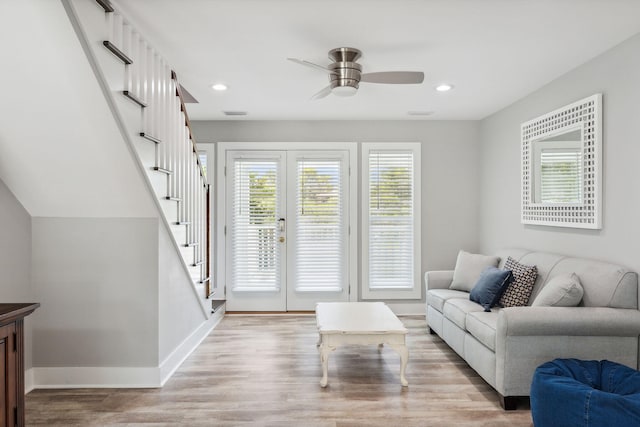 living room with french doors, ceiling fan, and light hardwood / wood-style floors