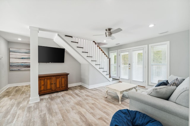 living room featuring ceiling fan and light wood-type flooring