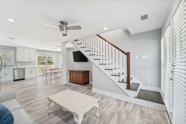 living room with ceiling fan and light wood-type flooring