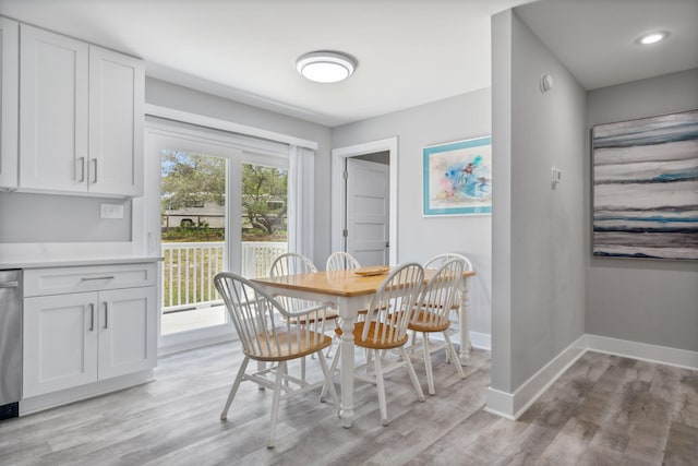 dining room featuring plenty of natural light and light hardwood / wood-style floors