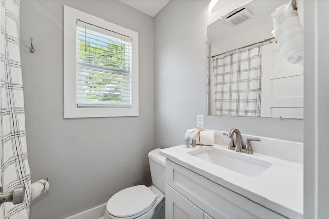 bathroom with vanity with extensive cabinet space and toilet