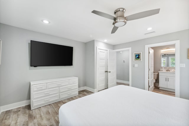 bedroom featuring a closet, ceiling fan, light hardwood / wood-style floors, and ensuite bathroom