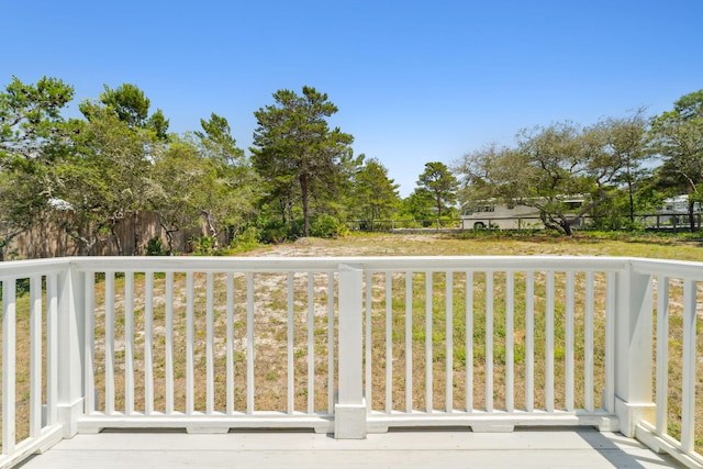 wooden deck featuring a lawn