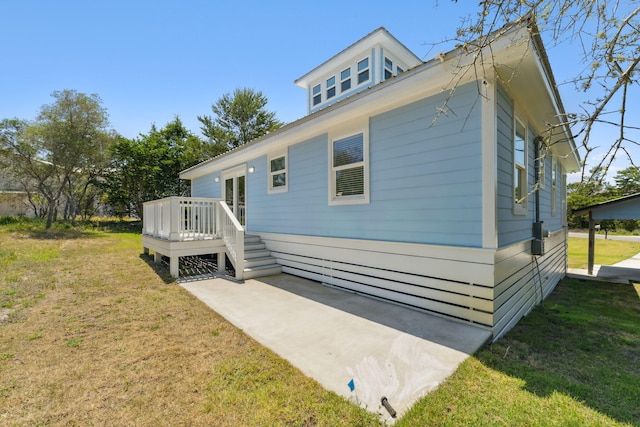 view of property exterior featuring a deck and a yard