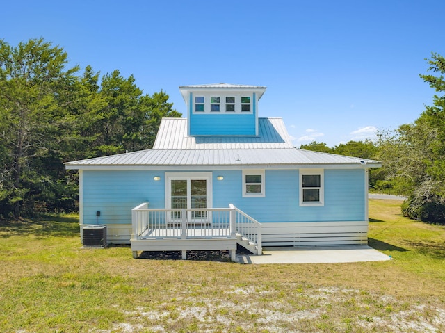 back of house featuring a deck, central air condition unit, and a lawn