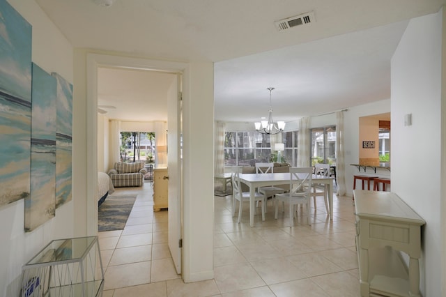 tiled dining area featuring an inviting chandelier