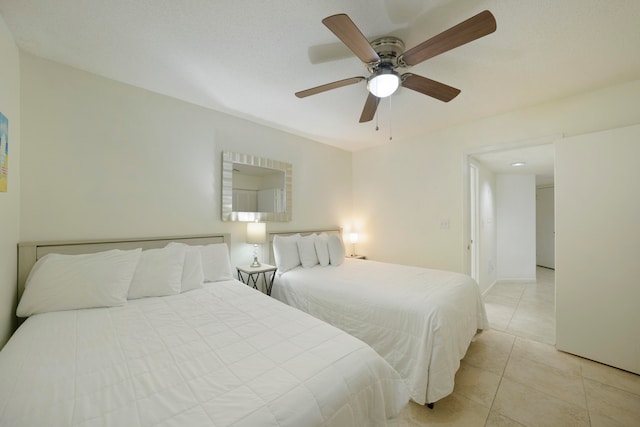 tiled bedroom with ceiling fan