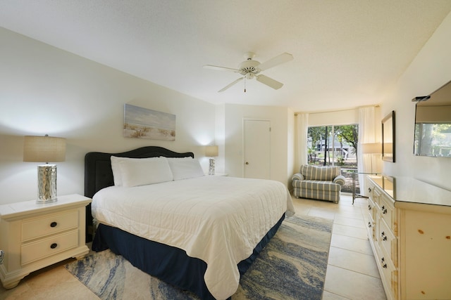 tiled bedroom featuring ceiling fan