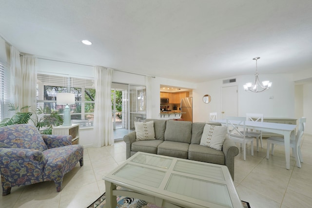 living room featuring a notable chandelier and light tile flooring