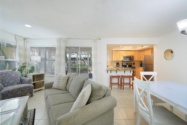 tiled living room featuring a healthy amount of sunlight