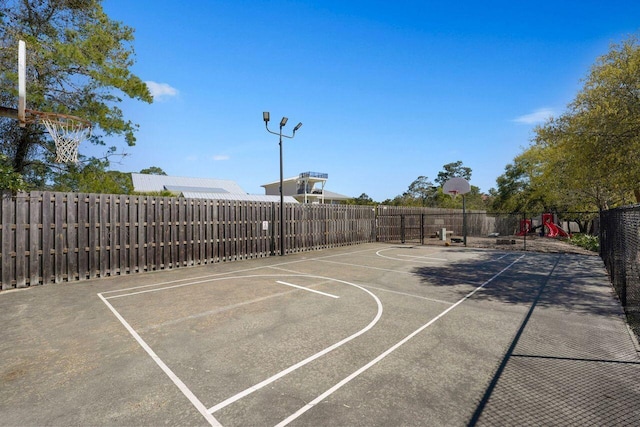 view of sport court with a playground