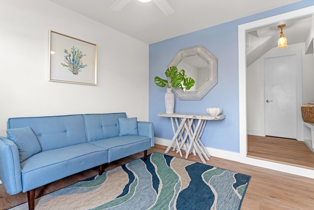 living room with light hardwood / wood-style flooring and ceiling fan