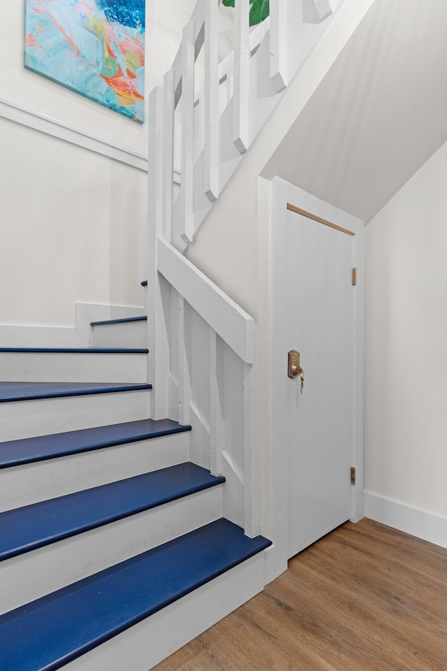 stairway with light wood-type flooring