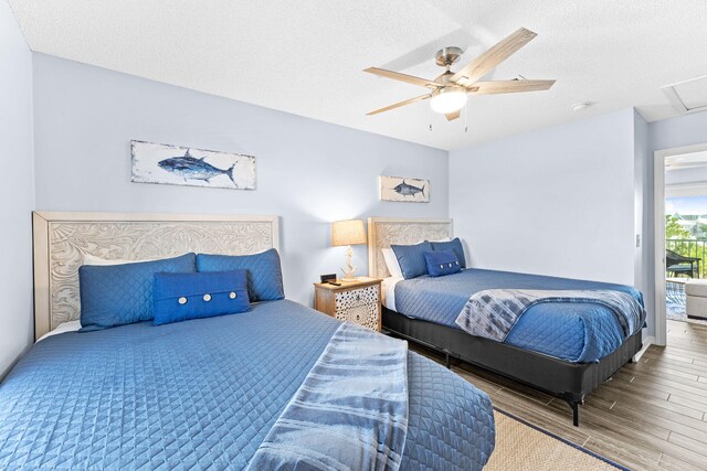 bedroom with wood-type flooring, a textured ceiling, and ceiling fan