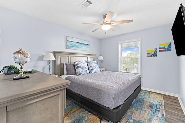 bedroom with ceiling fan and dark wood-type flooring