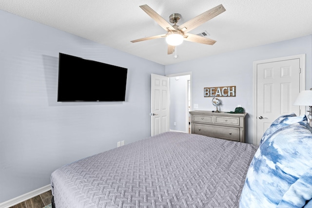 bedroom with dark hardwood / wood-style floors and ceiling fan