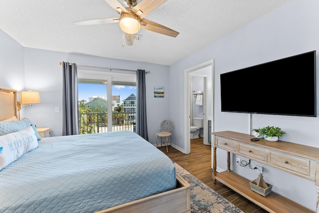 bedroom featuring access to outside, ensuite bath, dark wood-type flooring, ceiling fan, and a textured ceiling