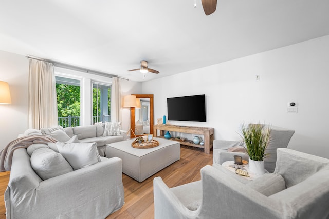 living room featuring ceiling fan and light hardwood / wood-style floors