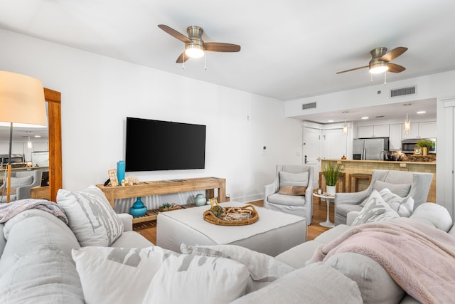 living room with hardwood / wood-style floors and ceiling fan