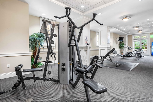 exercise room with carpet floors, crown molding, and a paneled ceiling