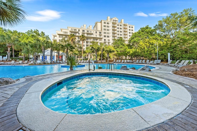 view of swimming pool featuring a community hot tub