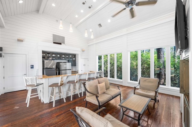 living room with beamed ceiling, high vaulted ceiling, dark wood-type flooring, and ceiling fan