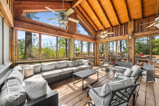 sunroom with ceiling fan, vaulted ceiling with beams, and wood ceiling